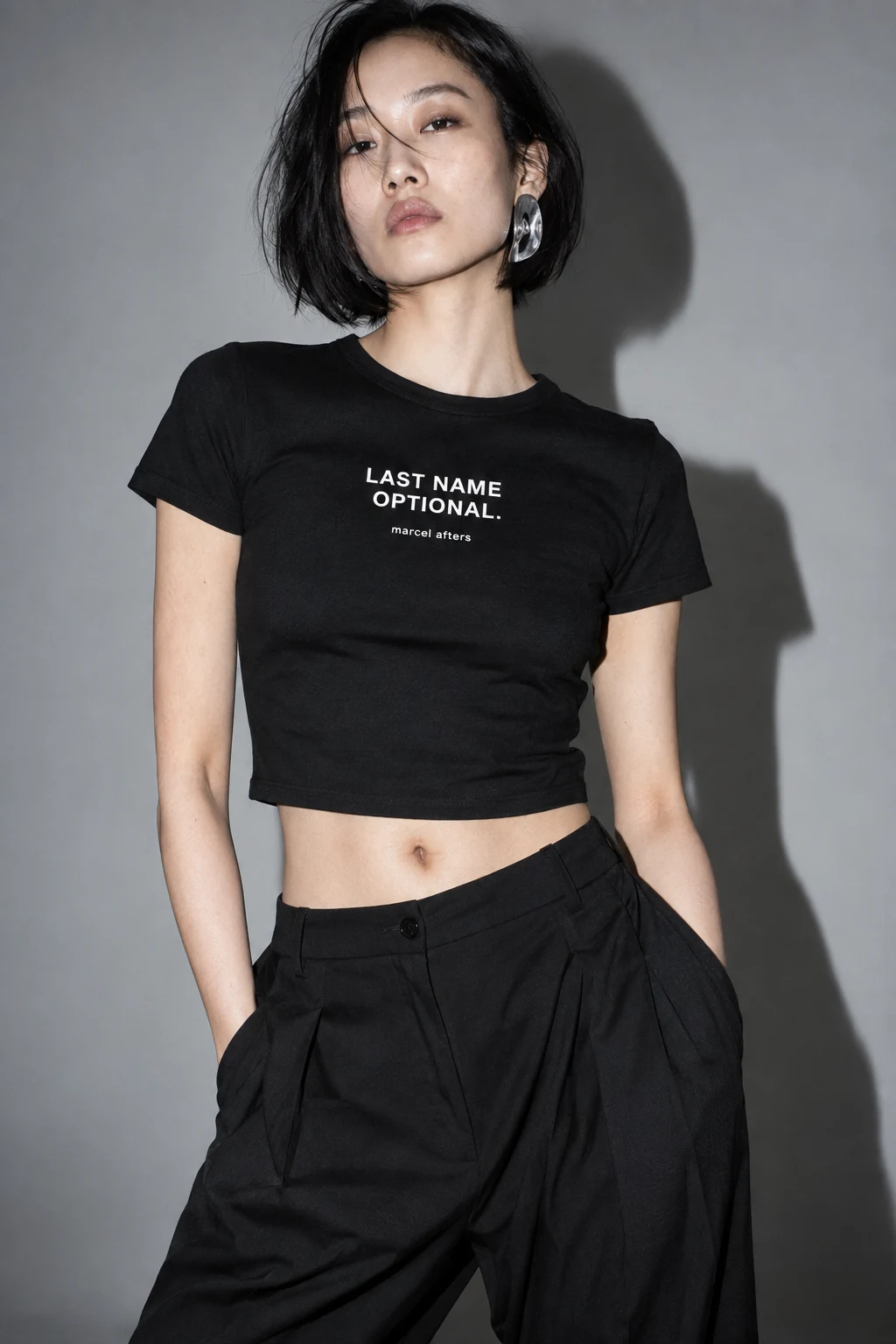 Adult woman in the Marcel Afters Last Name Optional shirt